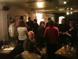 Group of people chatting and laughing at an evening tweetup in a Redhill bar
