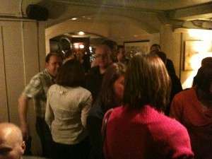 Guests mingling in a dimly lit bar at a Redhill and Reigate tweetup