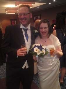 Veronica Pullen in her wedding dress with her husband Bill Boswell holding a bouquet
