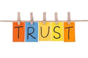 Letters spelling 'TRUST' pegged on a washing line