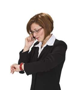 Stressed businesswoman in a suit on the phone with her eyes closed