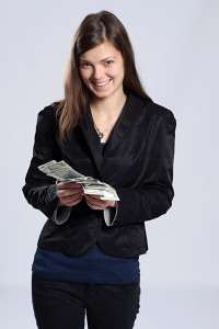 Woman in a black top fanning out banknotes