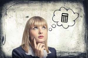 Woman thinking with a thought bubble showing a calculator, stock photo