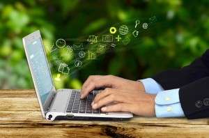 Laptop keyboard with glowing envelope icons flying out, stock photo