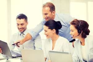 Two businesspeople shaking hands and smiling, stock photo