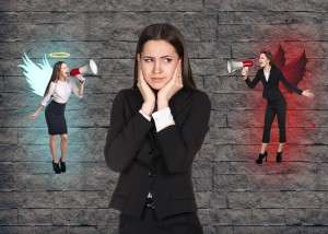 Woman in a suit holding her head while an angel and devil version of her argue